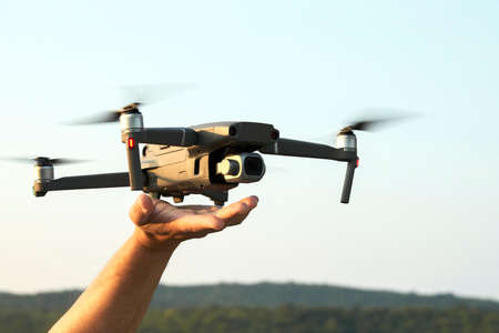 The drone lands on the outstretched arm. Selective focus. Copy space.の写真素材