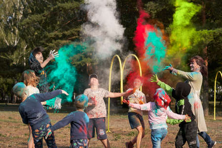 Russia, Naberezhnye Chelny, August 28, 2021: children and adults throw holi colored paints at each...