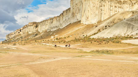 Crimea, Belogorsk, September 25, 2021: horseback riding along the canyon along the white rocky mountain.のeditorial素材