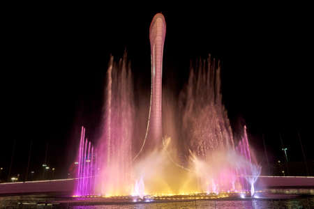 Russia, Sochi, April 16, 2021: Firebird light and music fountain with high colored water jets. Night...