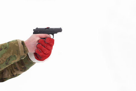 Pneumatic gun in outstretched man's hand on snowy white background. copyspace.