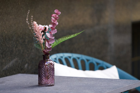Street cafe. Table with a decorative vase with a flower arrangement.