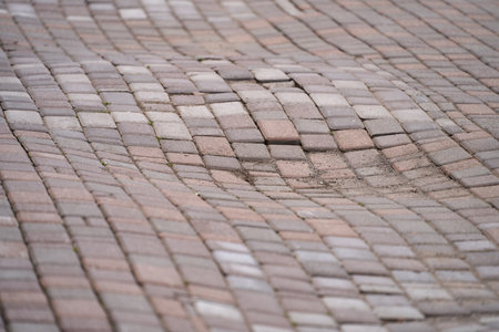 Sagging of paving slabs. Wavy surface of pavement. Copy space.