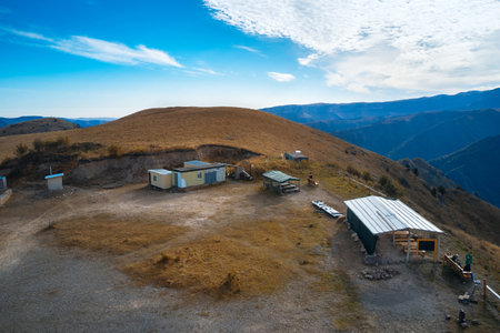 Equipped site in the mountains with summer lodging for tourists' rest stop. Shooting from a drone.