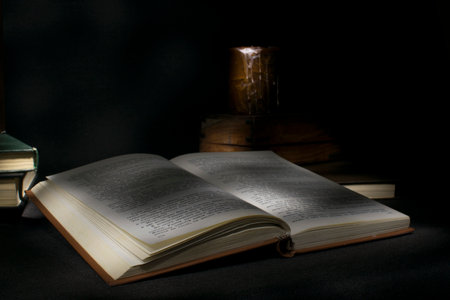 Open book and books on a dark background. Back to school.の写真素材