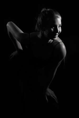 Girl on a black background in fashionable clothesの写真素材