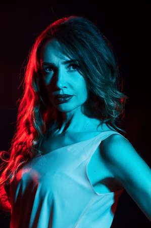 Girl illuminated by a turquoise filter