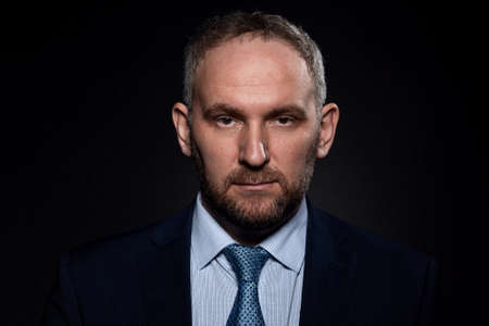 Man in a business suit on a black backgroundの写真素材