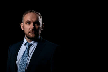 Man in a business suit on a black backgroundの写真素材