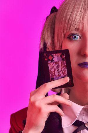 Girl with playing cards in hands on a colored background