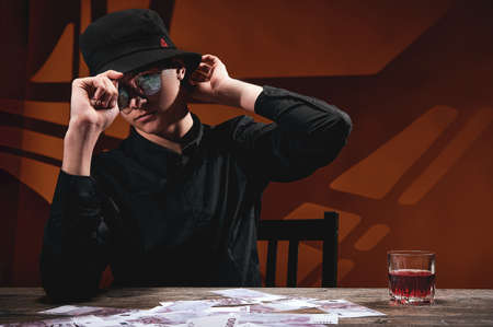 A cool man in round glasses at the money tableの写真素材