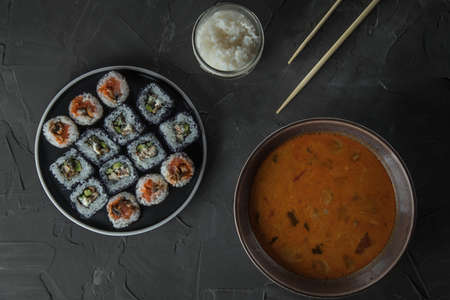 a bowl of tom yam soup, a jar of rice and a set of sushi. Top viewの写真素材