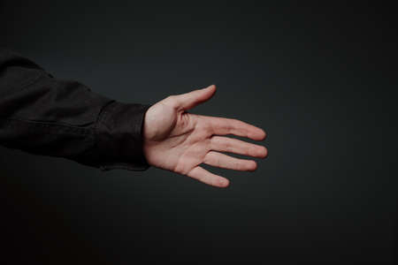 a man's hand reaching for a handshakeの写真素材