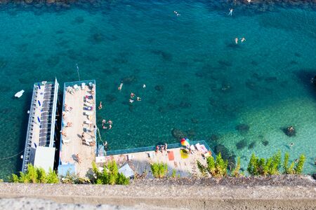People sunbathing and bathing in Sorrentoの写真素材