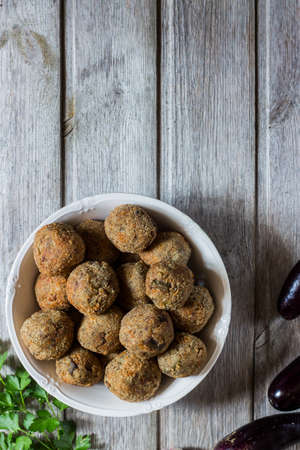 Meatless eggplant meatballs on wooden background.の写真素材