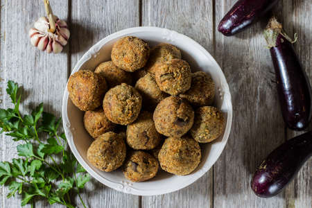 Meatless eggplant meatballs on wooden background.の写真素材