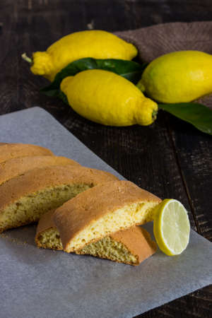 Homemade lemon cookies. Black wooden background with lemons and leaves.の写真素材