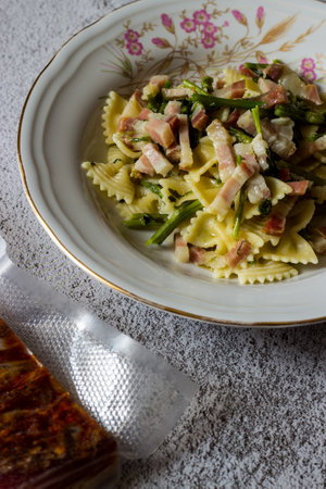 Farfalle with asparagus and bacon, dish of Italian cuisineの写真素材