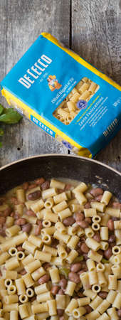 Italian pasta De Cecco and beans in a pan with celery and onionのeditorial素材
