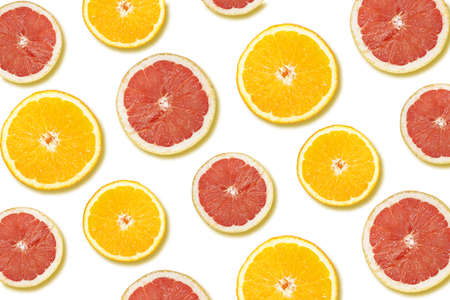 A pattern of an orange and a grapefruit halves on a white surfaceの写真素材