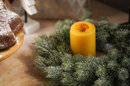 A beeswax candle in the christmas wreatheの写真素材