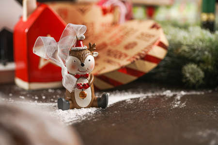 A christmas tree ornament - a reindeer, surrounded by festive decoration