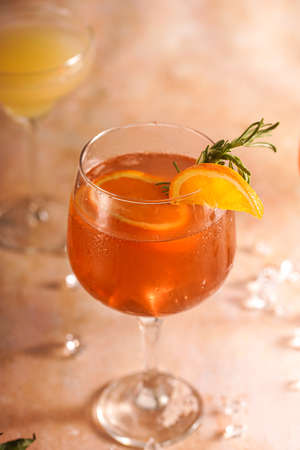 Orange christmas alcoholic beverage and lemonade with oranges, tangerines and rosemary in many glassesの写真素材
