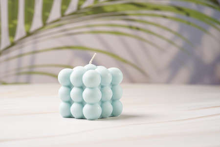 One blue square bubble candle on a tropical backgroundの写真素材