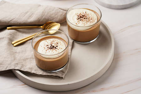 Italian chocolate and coffee mousse dessert semifreddo - half-frozen ice cream with whipped cream and cocoa powder in small glassesの写真素材