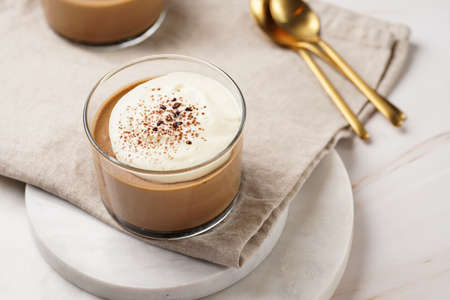 Italian chocolate and coffee mousse dessert semifreddo - half-frozen ice cream with whipped cream and cocoa powder in small glassesの写真素材