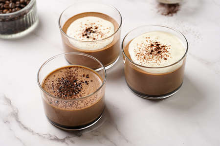 Italian chocolate and coffee mousse dessert semifreddo - half-frozen ice cream with whipped cream and cocoa powder in small glassesの写真素材
