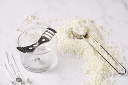 Tools and supply for candle-making: wicks, soy and coconut wax, gold foil, colors and aroma oils, bubble candleの写真素材