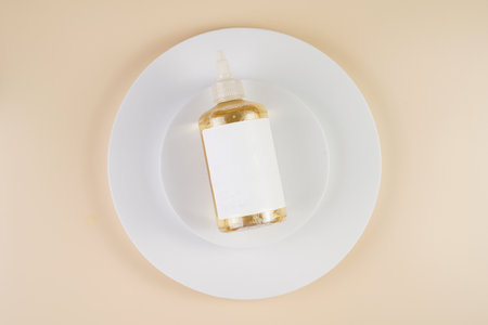mock-up of a transparent bottle with liquid cosmetics and empty label on white round podiums on...