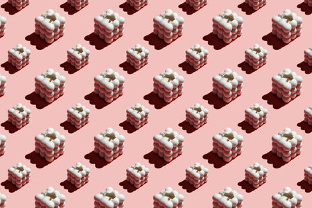 A hard light pattern of a light gray bubble candle on pink seamless background