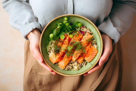 Woman holding a trendy dish poke bowl - quinoa, wakame seaweed, tomatoes, cucumber, avocado, salmon. Healthy eating concept. Generative AI technologyの素材