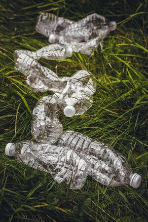 Plastic bottles in the green grass. Problem in the natural environment, pollution of nature is not decomposing plastic. Protection of Nature.の写真素材