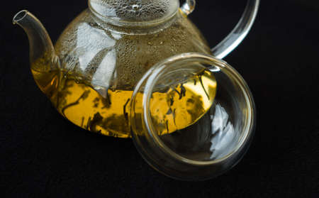 greentea is poured Into a glass mug, splashes and bubbles
