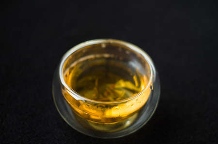 greentea is poured Into a glass mug, splashes and bubbles