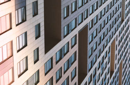 Facade of a modern building.Background with rows of glass windows.の写真素材