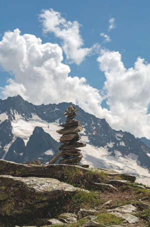 Balance of stones. Balancing stones on the top of boulder. Close up. Balance of stones on a blue sky...