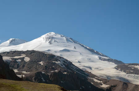 The Caucasian mountain Range. Perspective of caucasian snow mountain or volcano Elbrus. Landscape...
