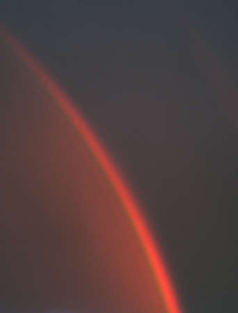 abstract natural background. A rainbow on a dark stormy sky at sunset. Copy space.の写真素材