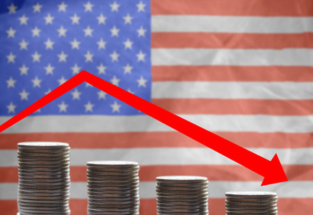 Coins on the background of the US flag Graph of falling incomes in America. copyspace.の写真素材