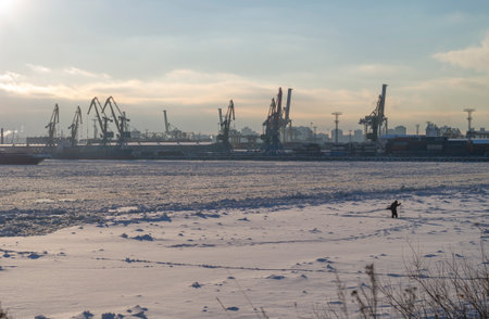 Cargo Docks in St. Petersburg. Winter landscape on a frozen river. industrial landscape at sunset.の写真素材