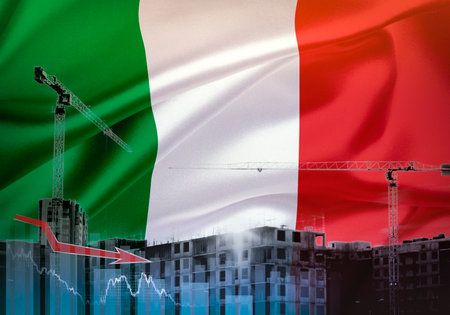 Construction cranes on the background of the flag of Italy. The concept of a crisis in construction.の写真素材