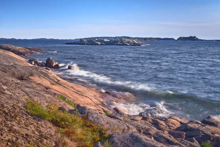 The coast of Porkkala in the evening of a summer day waves the stones of the island.の写真素材