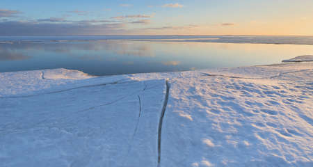 Coast of Gulf of Finland of the Baltic Sea in the end of winter: open water, before sunset, ice...