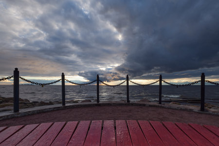 Approach of thunderstorm cloud at sunset: shore of Gulf of Finland of Baltic Sea.の写真素材
