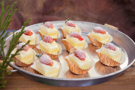 The Cream cakes with strawberry served on the tray, catering, outdoor foodの写真素材