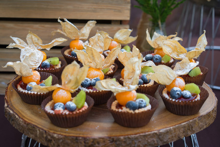 Tartlets with fresh berries on the table with decoration. Food for catering or banquet party. Close Upの写真素材